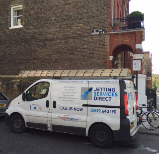 Clearing blocked balcony drain at the front of the property in Cheyne Gardens, Chelsea, West London SW3