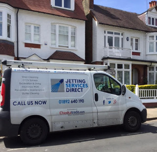 Cleraring blocked drain (manhole) at side of property in Rusthall Avenue, Chiswick, West London W4