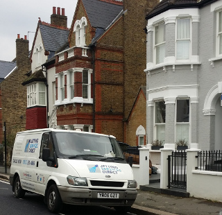 Cleaning blocked drain at rear of property in Klea Avenue, Lambeth, South London SW4